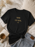 She Leads — Feminine Gold Script Leadership Tee