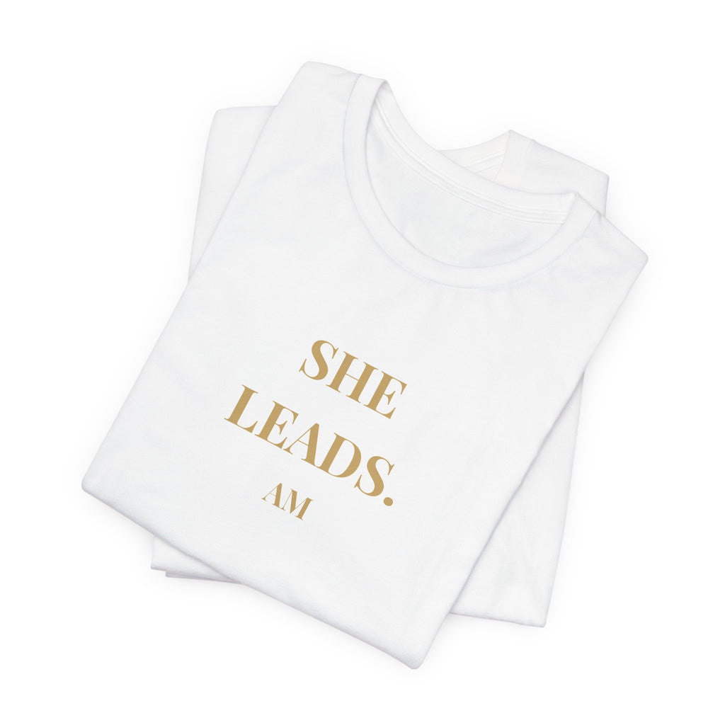 She Leads — Feminine Gold Script Leadership Tee